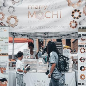 Crowd enjoys mochi donuts at Mississauga's outdoor cultural event.